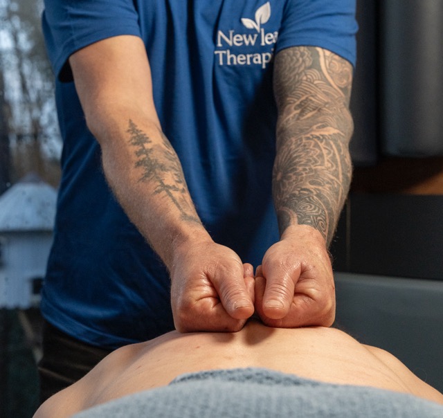 Deep tissue massage technique showing therapist applying pressure